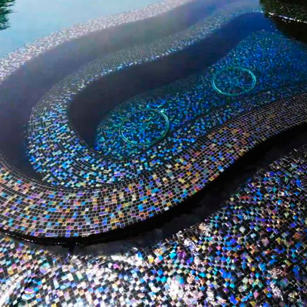 spa in a bright black overflow pool by Platinum Pool