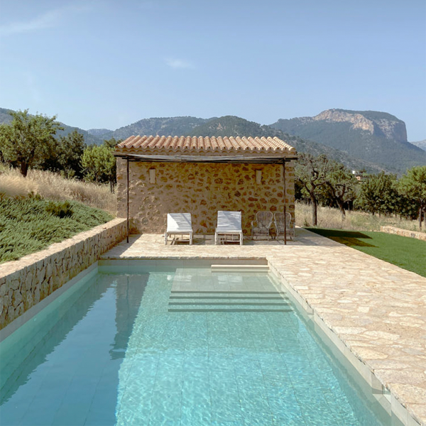 private pool in a rustic setting by Jorge Bibiloni Studio