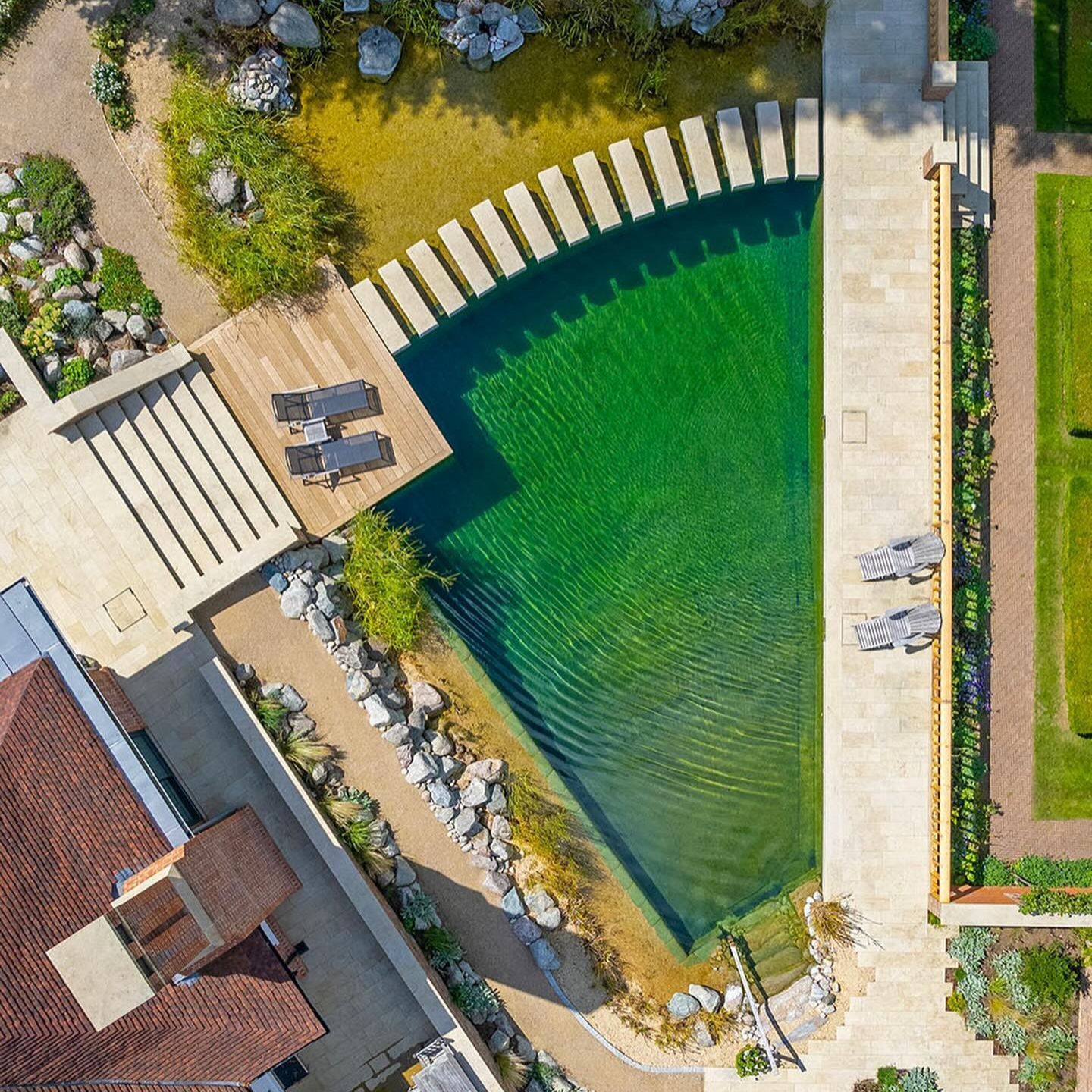 Drone view of a beautiful natural pool, exclusive geometric designed by Gartenart, in a country house