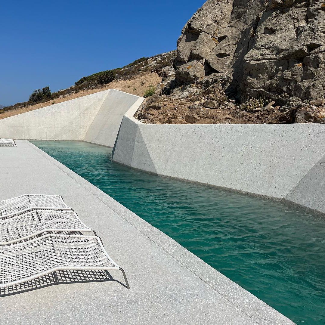 Private lap pool, with a unique and different design next to the rocks, by Alpha Pools