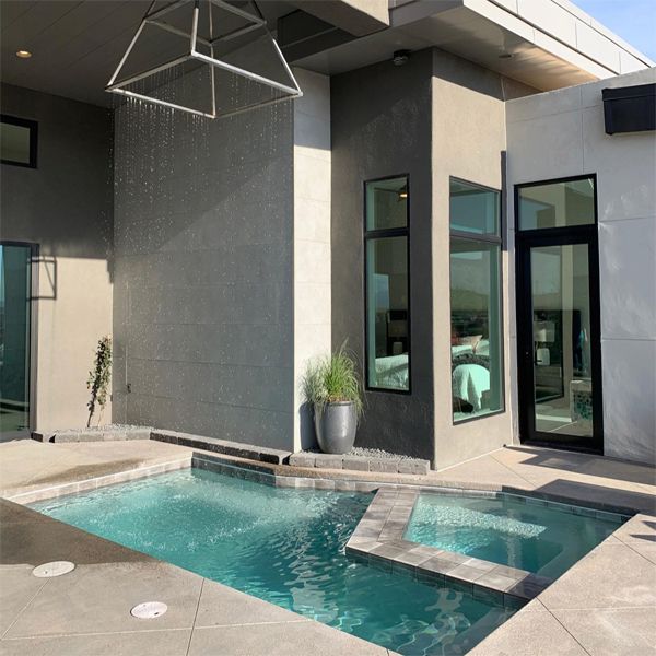 custom mini pool with a built-in spa and a lamp shaped water feature, rain effect, by Cutting Edge Pools, in a small private patio,