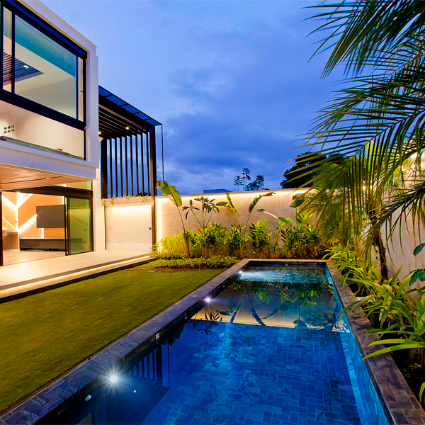 private pool with coating in natural stone at night, by QBO3