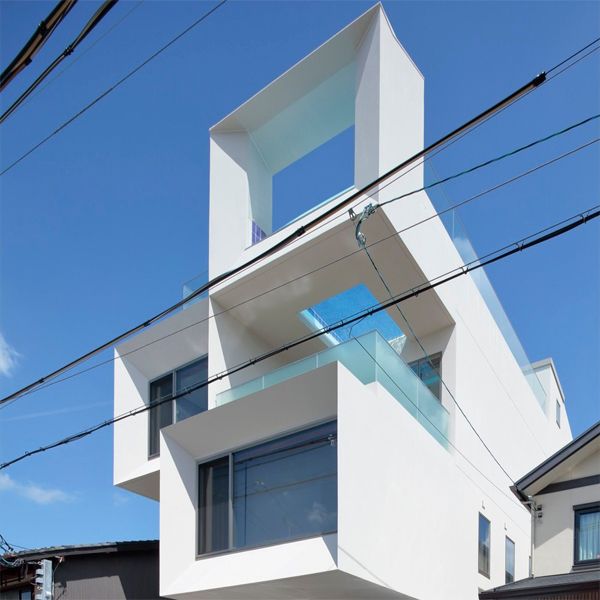 Modern design house, by Eastern Design Office, based on several concrete cubes stacked in 2 columns and 4 levels, with an infinity pool with windows in the ground, located on the rooftop