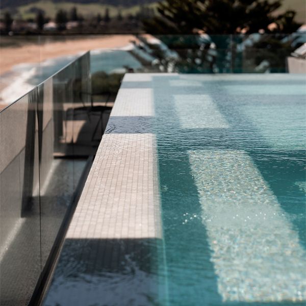 bright white tiles of an infinity pool in a project by Futureflip
