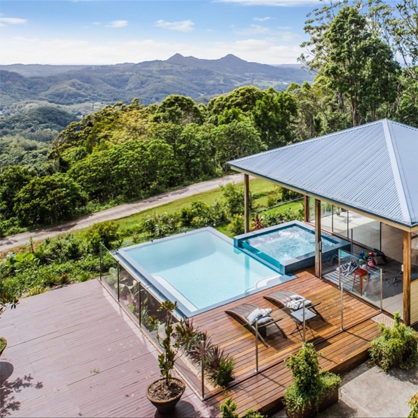infinity pool and overflow spa with transparent wall by Dynamic Pool Designs