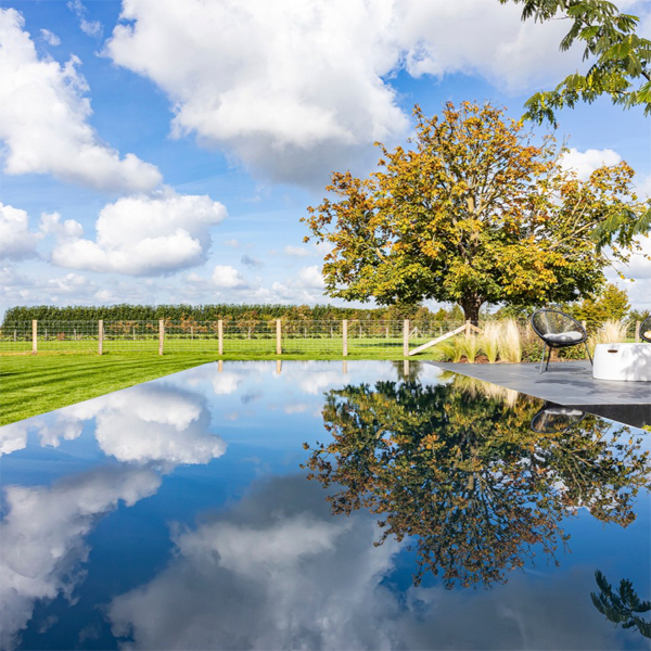 mirror pool by Art Pools, reflecting the sky, the clouds and the trees