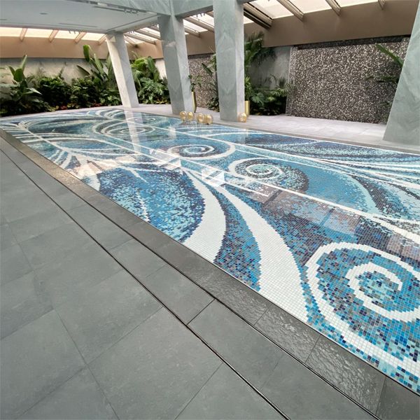 Movable floor in an indoor pool coated by custom glass mosaic tiles, by Unik Pools