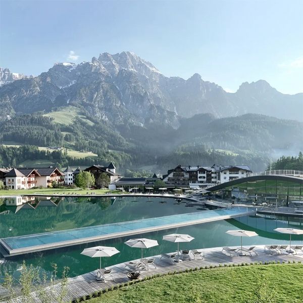 drone view of a combination of an infinity pool in stainless steel and a large natural pool in a project by Hadi Teherani for the Krallerhof spa hotel