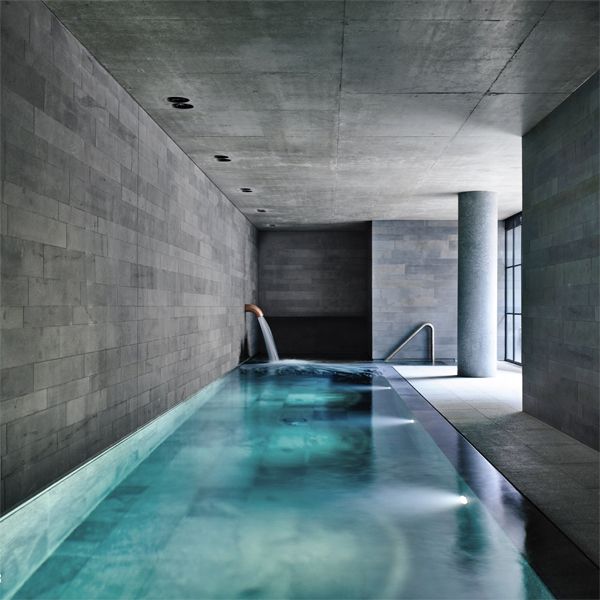 minimalist indoor overflow pool in a project by B-E Architecture
