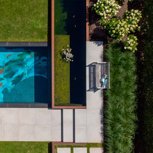 drone view of a mirror pool with a unique abstract drawing coating, by H2eau Systems, in a private garden with a pond