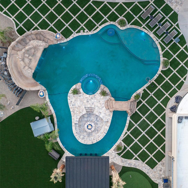 drone view of an outdoor living space with a great pool by Sherwood Outdoors