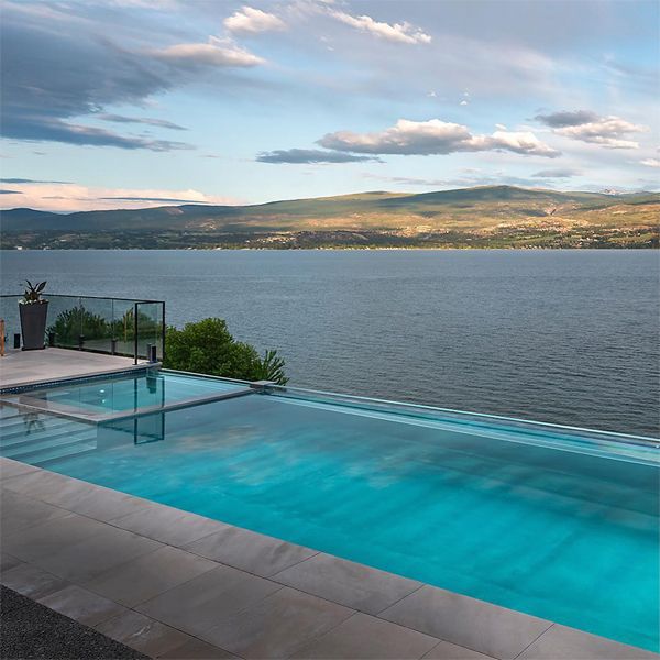 Stainless steel infinity pool with built-in spa, by Valley Pool and Spa, on a hill with lake view