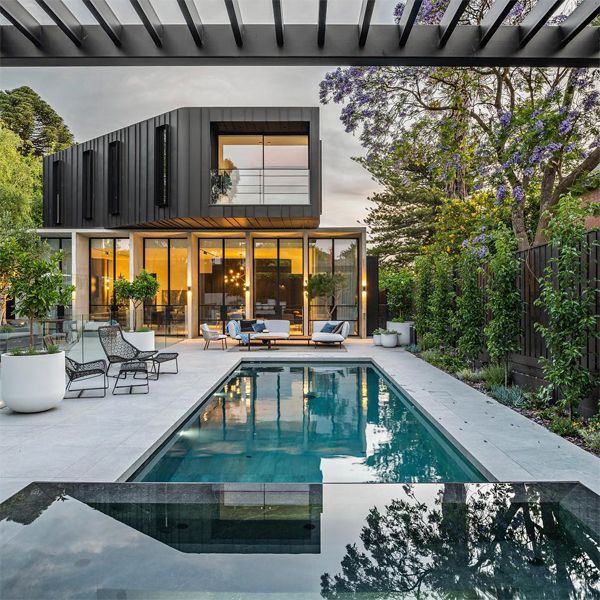 minimalist pool and infinity spa in contrast, by Aquacon Pools, at sunset