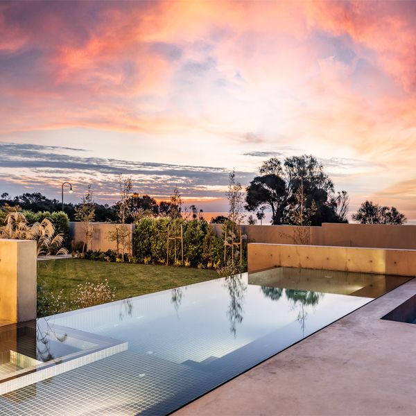 dark infinity pool and spa at sunset, by Coastal Pools and Spas
