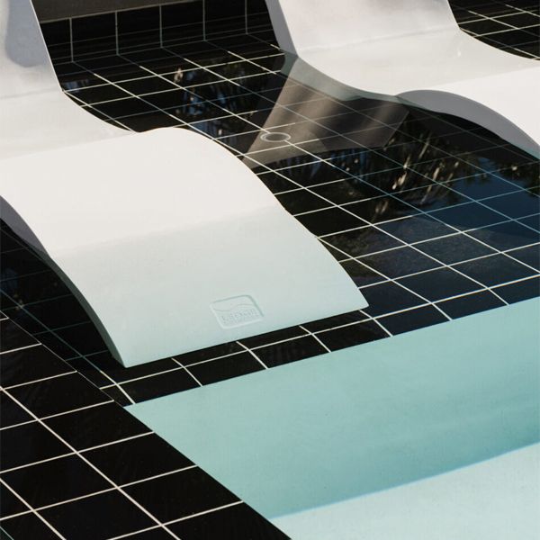 sun loungers inside a swimming pool in contrasting color, in a project by Michelle Boudreau Design