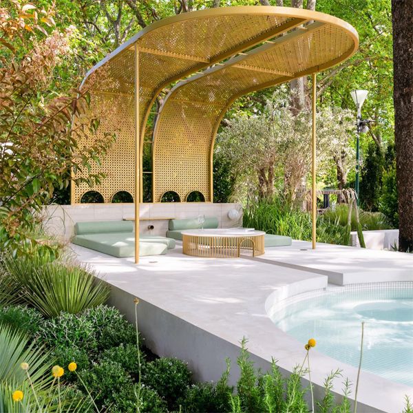 Custom white plunge pool with a modern and refined rounded design, by TLC Pools in a luxury landscaping project with a golden pergola