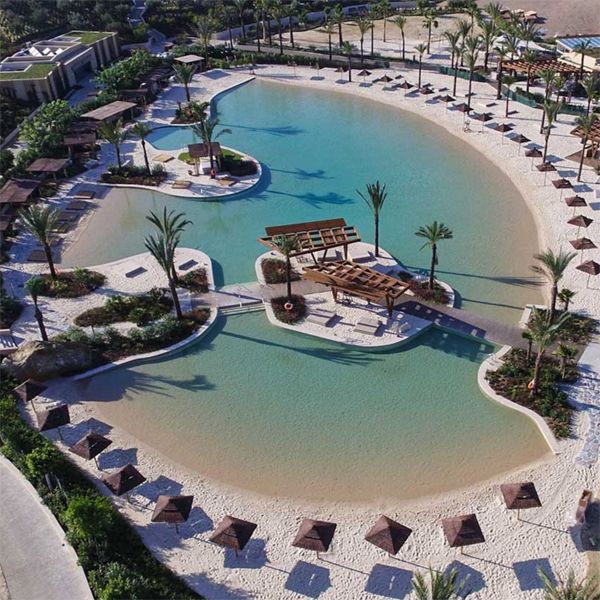 drone view of a custom sand pool, beach type, for a resort, by Myrtha Pools