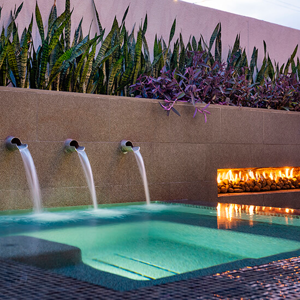 Water jets on the wall over the swimming pool