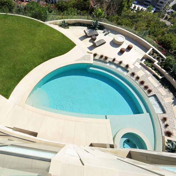 drone view of a custom infinity pool with built-in spa, in a project by Landry Design Group