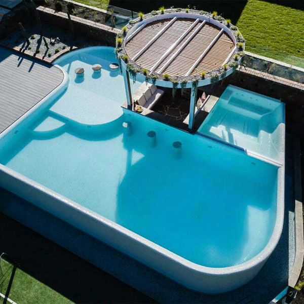 different overflow pool with spa drone view by Striking Pools
