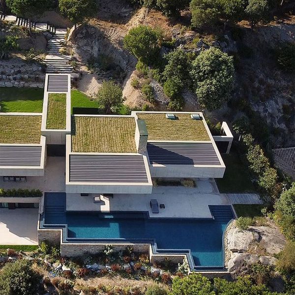 drone view of a custom infinity pool built over a hill, in a project by Ramon Esteve
