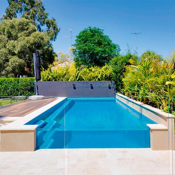 semi-inground private pool with a see-through wall by Jade Pools