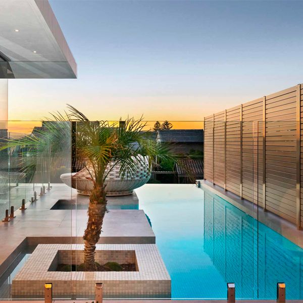 modern and stylish infinity pool at sunset in a house by Larsen Homes