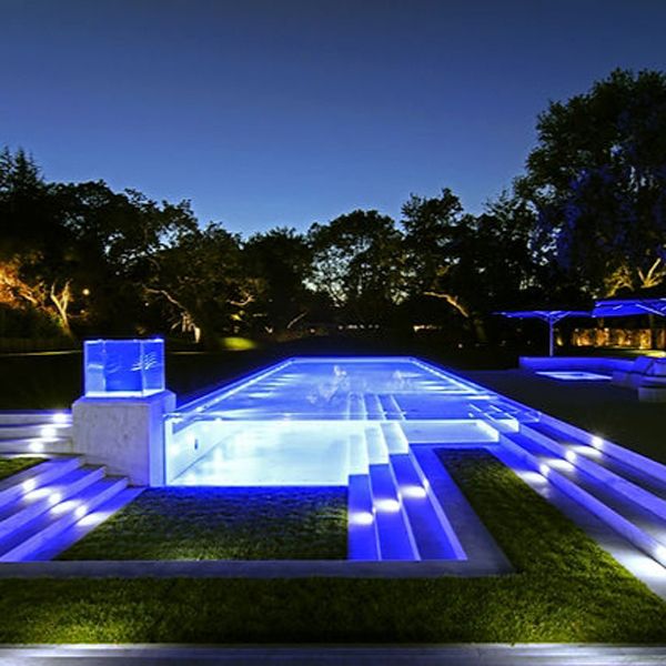 transparent unique pool at night by Paradise Pools and Gardens