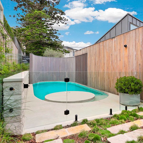 rounded shaped custom mini pool by Focus Pools, in a modern backyard