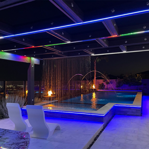 geometric above ground pool and spa at night by G.O. Construction