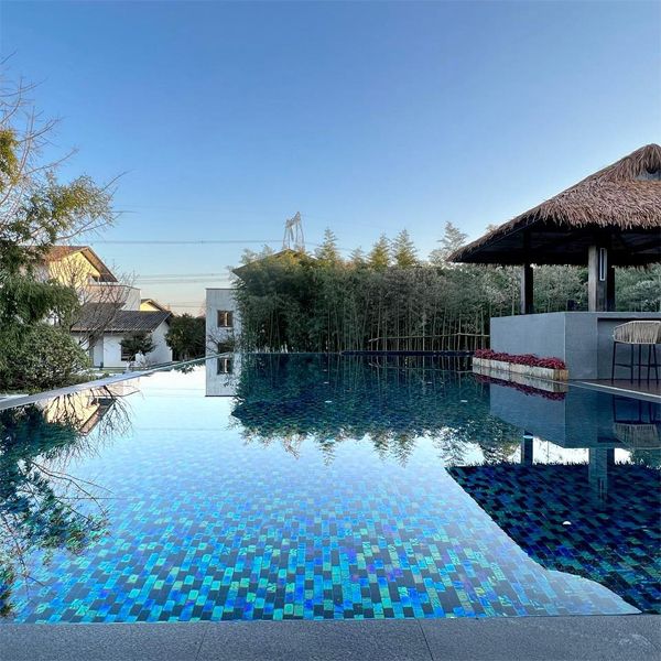 transparent infinity pool with bright mosaic glass tile coating, by Aupool