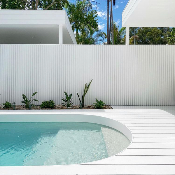 mini pool surrounded by white decking and tropical plants