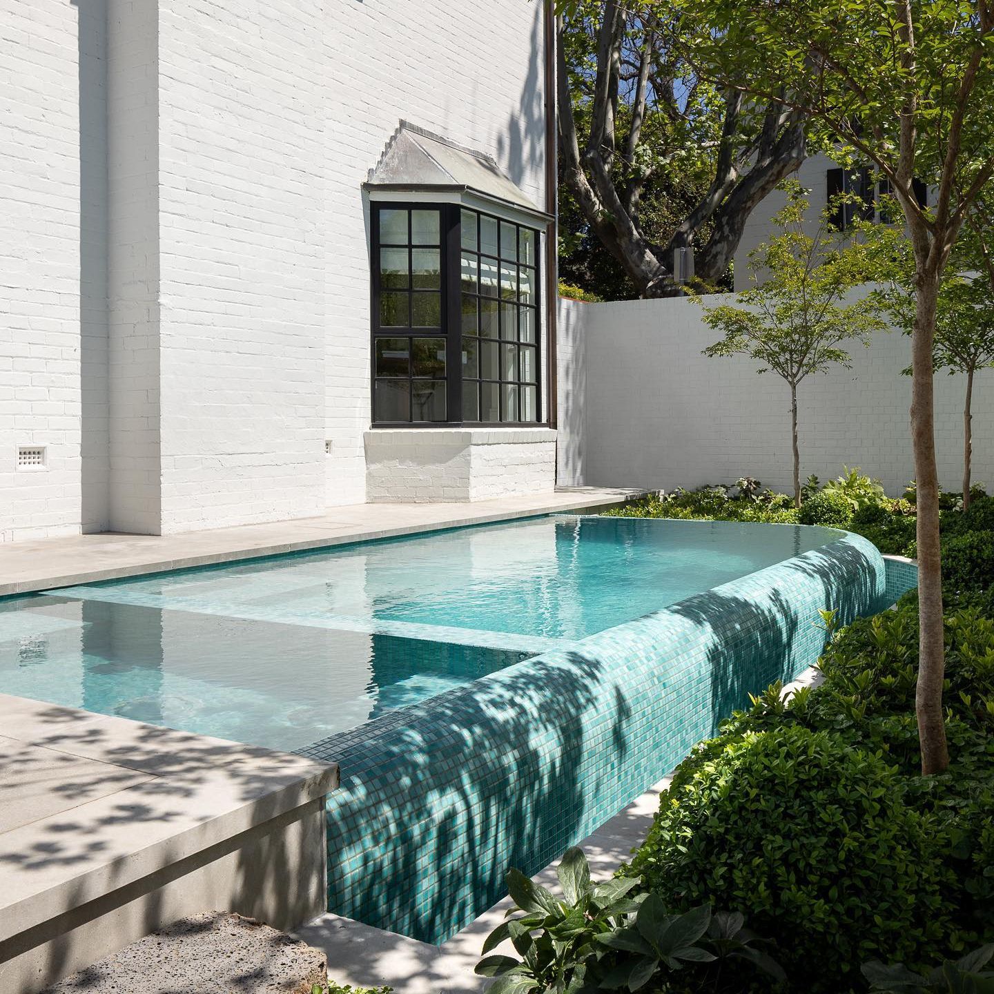 Custom infinity mini pool with built-in spa, in a small space, by Grange Pools