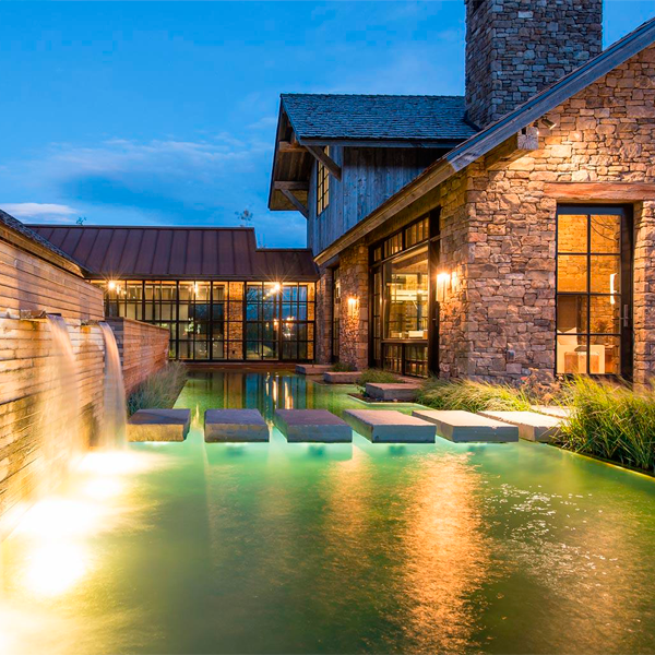 natural pool and landscaping at night by Verdone Landscape Architects