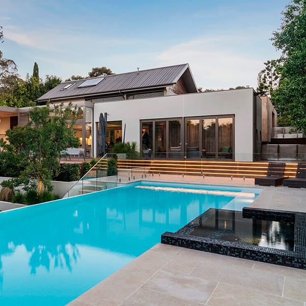 Landscaping project with a custom infinity pool in a modern house, by Coolabah Landscape