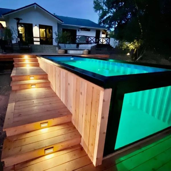 Container pool with an underwater window, by Trek Pools, at night