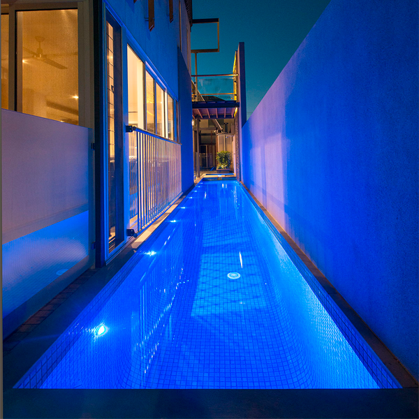 lap pool close to the house at night