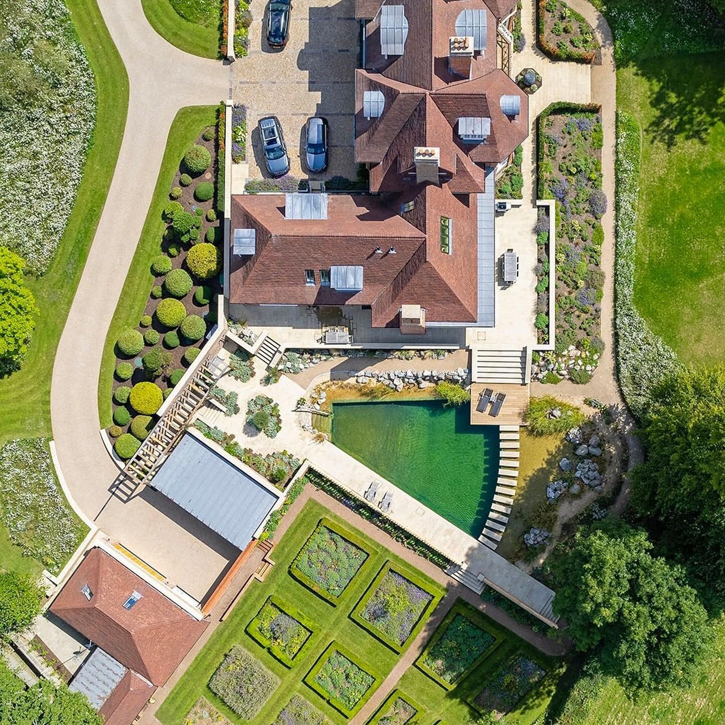Drone view of a beautiful natural pool, exclusive geometric designed by Gartenart, in a big country house