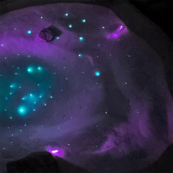 drone view of a starry sky at the bottom of a mini sand pool, by Beach pool, using fiber optic lighting