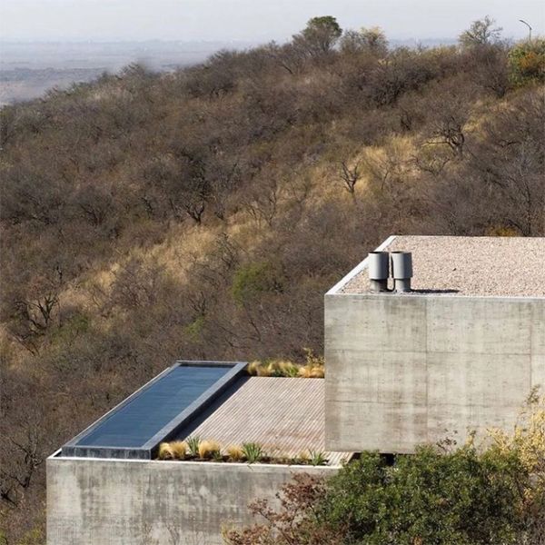 Drone view of a modern and minimalist house project with an infinity pool, by Gaston Sironi Arquitectos