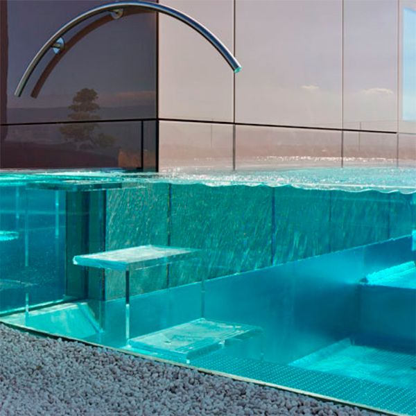 steel infinity pool with transparent walls built in a rooftop, by Nicollier Group