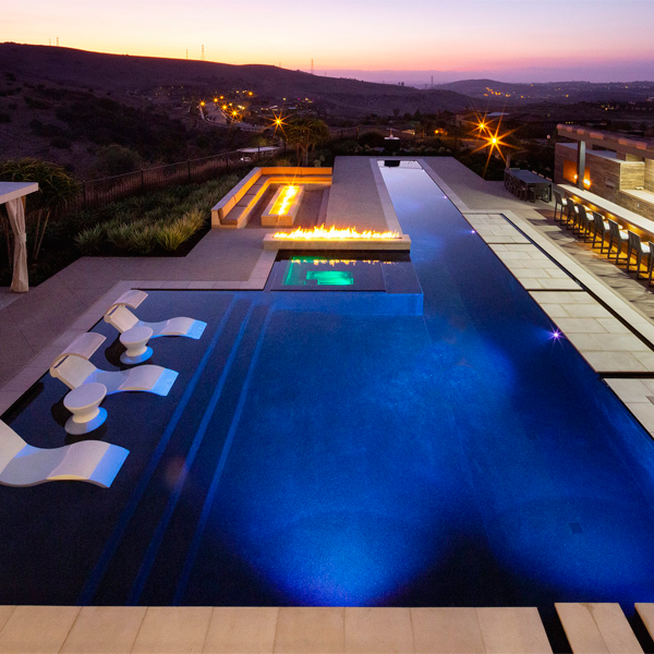 black lap pool and spa at night, by Mission Pools