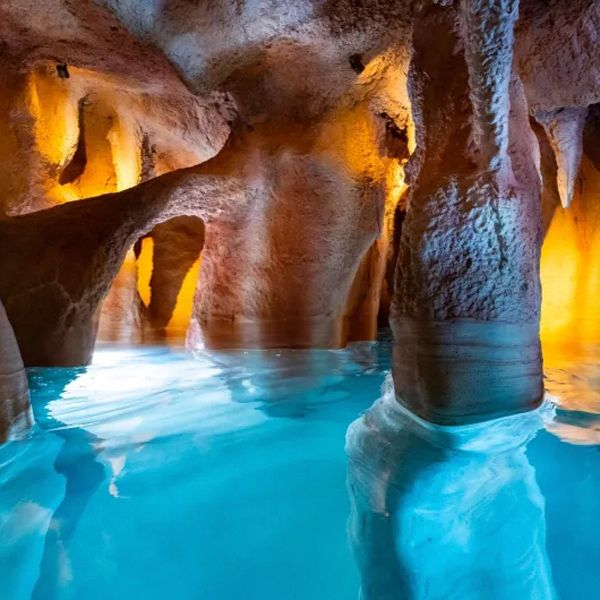 Custom indoor pool, simulating the interior of a cave, by Piscines Ondine