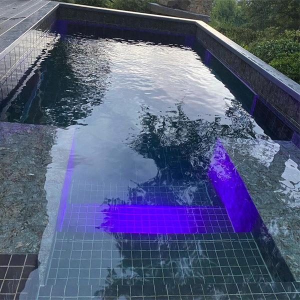 mini pool with an underwater window by Via Pools