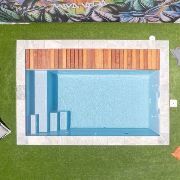 drone view of a prefab mini pool with an automatic pool cover, by MCR Piscines