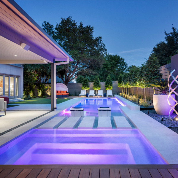 private custom pool at night by Elite Outdoor Living