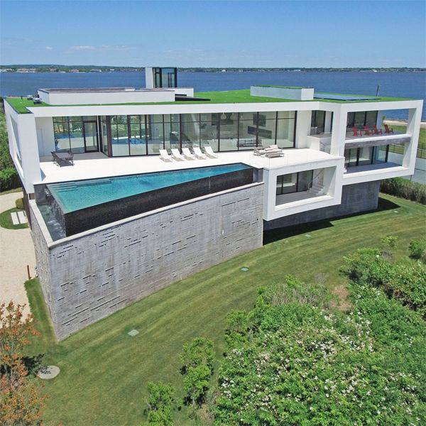 Drone view of a spectacular cantilevered infinity pool, in a super luxury, next to the sea, by DRPILLA