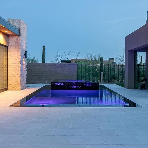 black mirror pool and spa at night, by Flowing Wells
