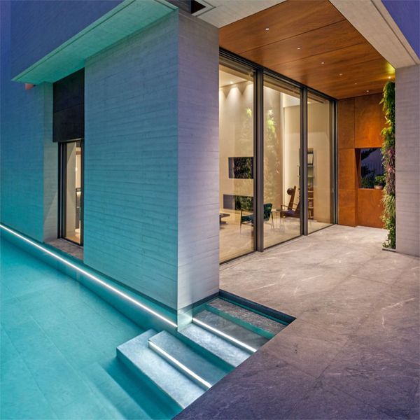 minimalist modern pool at night, in a project by Divercity Architects