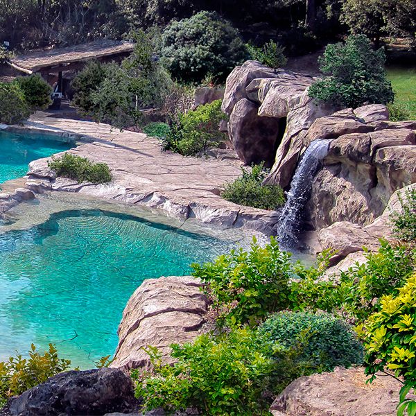 A unique custom pool and landscape, with reconstituted rocks, artificial waterfalls... by Waterworld
